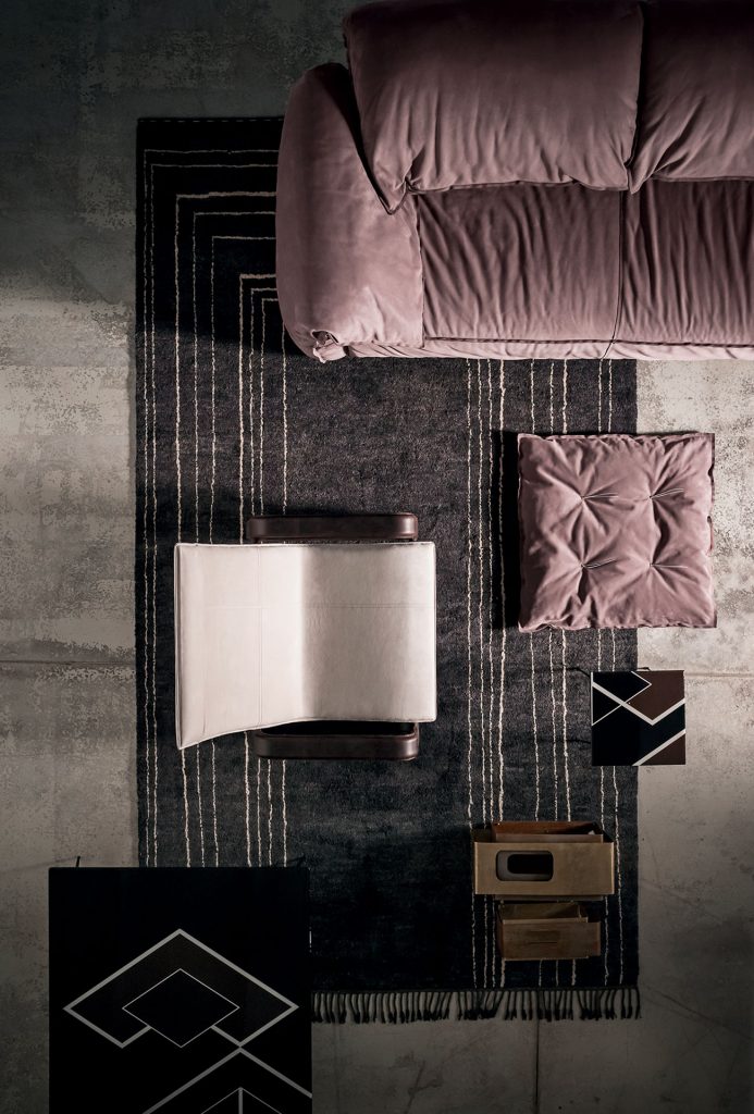 Berbère Dark Grey + Natural | Pattern B. Rug decorated with a woolen stitching in a living room.