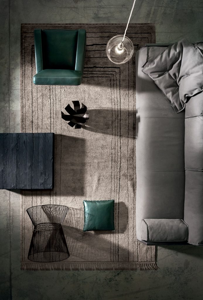 Berbère Light Grey + Dark Brown | Pattern B. Rug decorated with a woolen stitching in a living room.