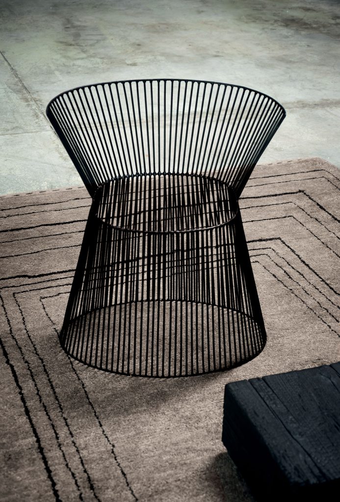 Berbère Light Grey + Dark Brown | Pattern B. Rug decorated with a woolen stitching in a living room.