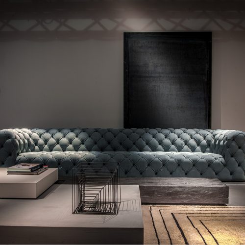 Berbère Natural + Black | Pattern B rug decorated with a woolen stitching in a living room.