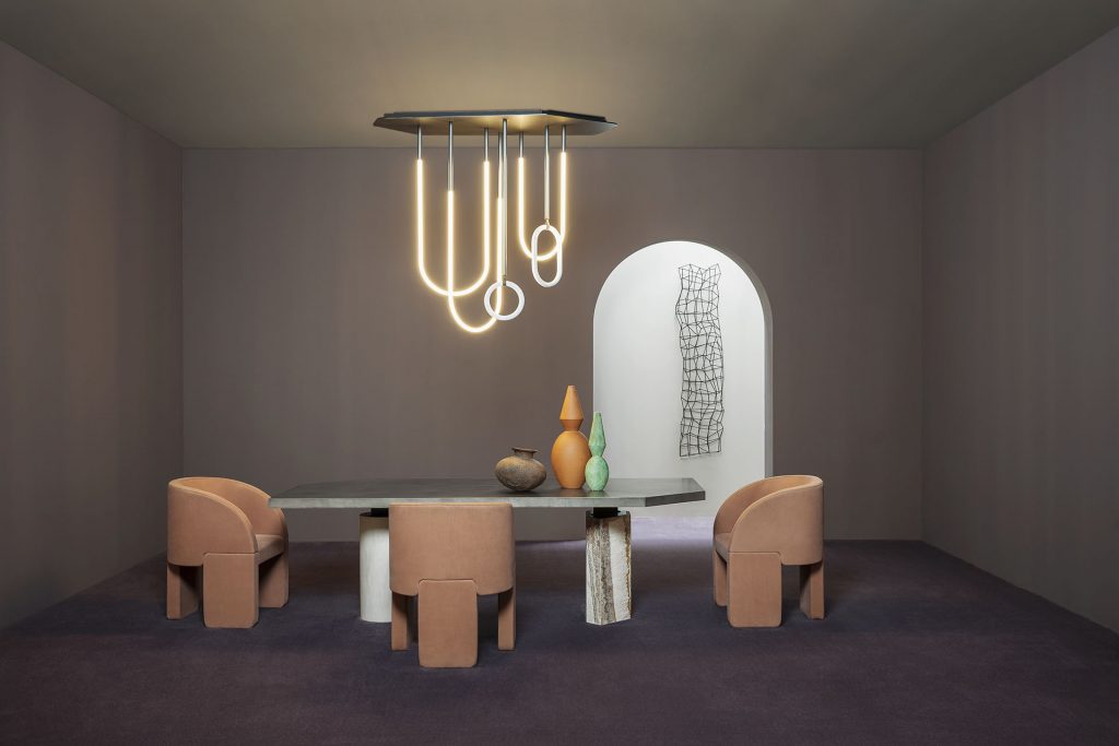 three armchairs made of orange-colored leather with three support legs in a dining room