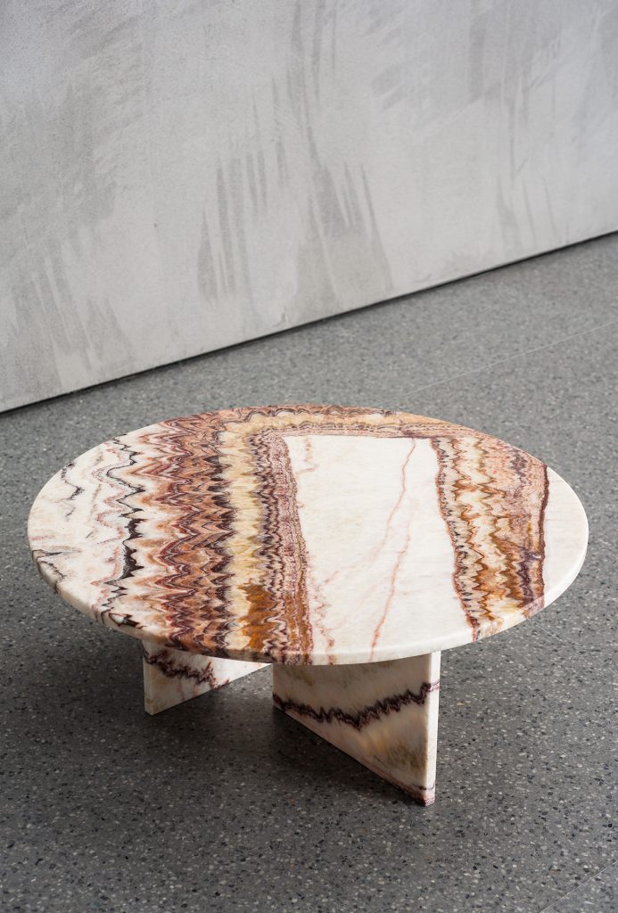 Gradient brown marble table with imperfect and elegant bases with a gray background