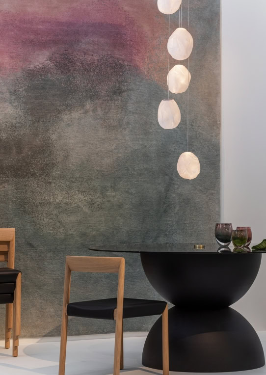 A Seventy Three V lamp in white blown glass in fabric shape, braided metal coaxial cable, electrical components, brushed nickel in a dining room.