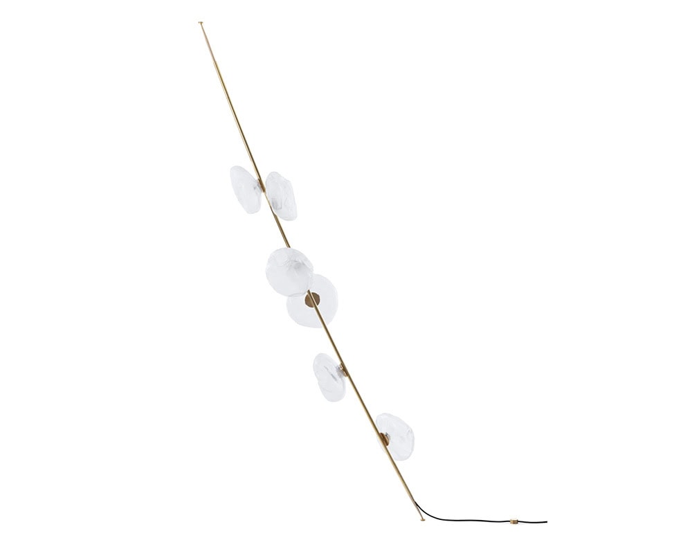 Floor lamp with a warm brass stem and five frosted glass orbs. Its sculptural form adds vertical elegance and soft illumination to refined contemporary interiors.