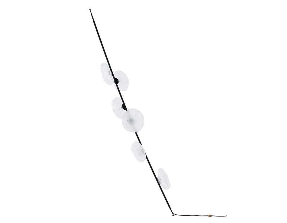 Leaning floor lamp with a sleek black stem and five frosted white glass orbs. A bold and sculptural presence ideal for modern interiors seeking both function and artistic flair.