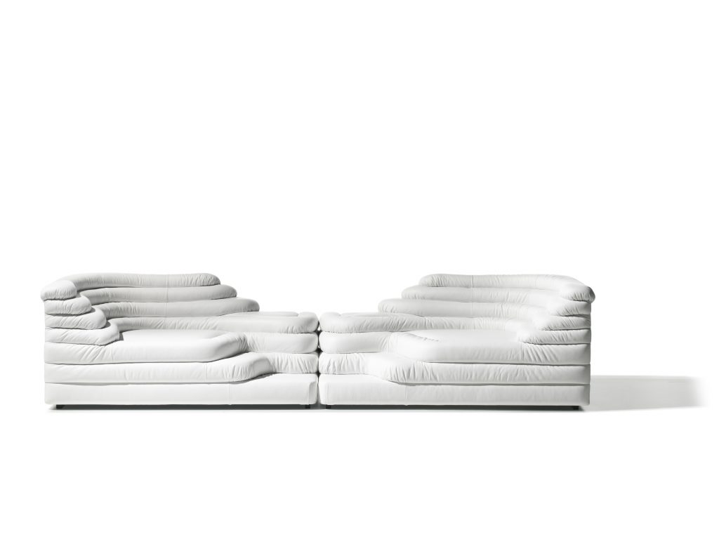 Two white DS Thousand twenty five sofa elements. The single element is a terraced hill with widths and depths that vary in tapering steps on a white background.
