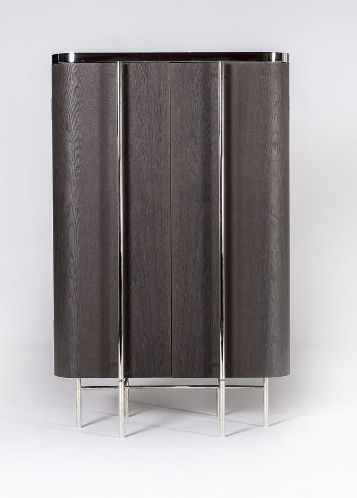 vertical furniture made of a wooden, glass and steel base with internal drawers on a white background