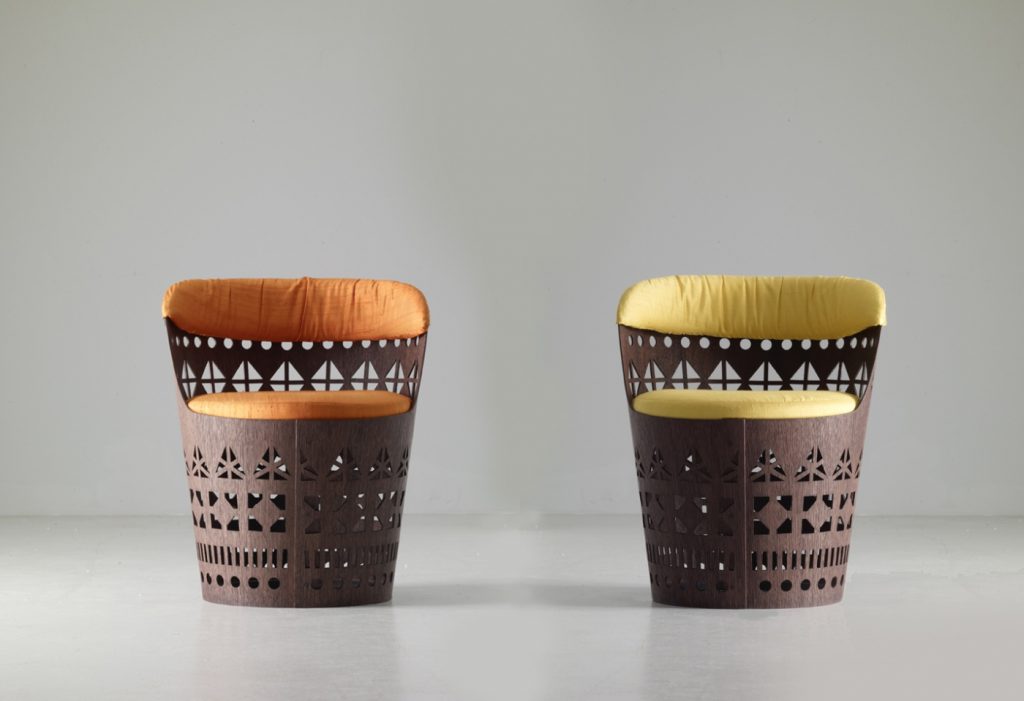 two small armchairs made from a wooden base and a cushion in a yellow and orange colour tone on a white background