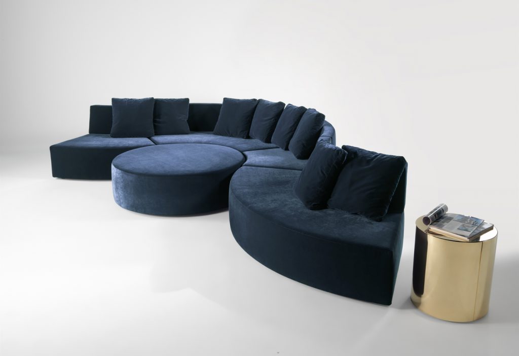 modular sofa made on a wooden base and covered in a blue snake-shaped fabric on a white background