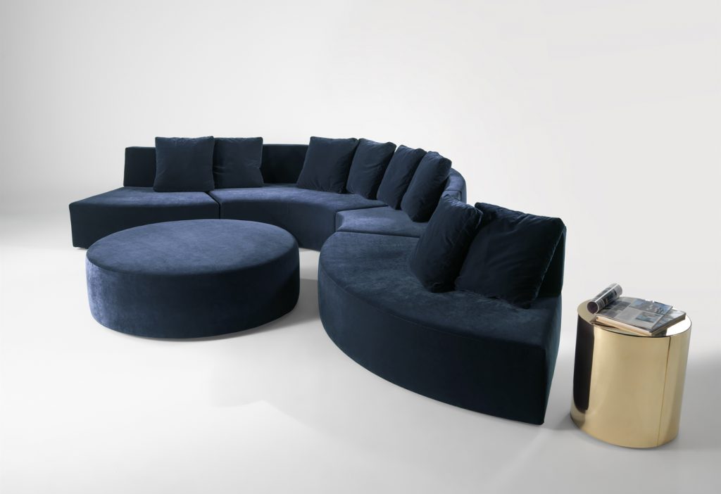 modular sofa made on a wooden base and covered in a blue snake-shaped fabric on a white background