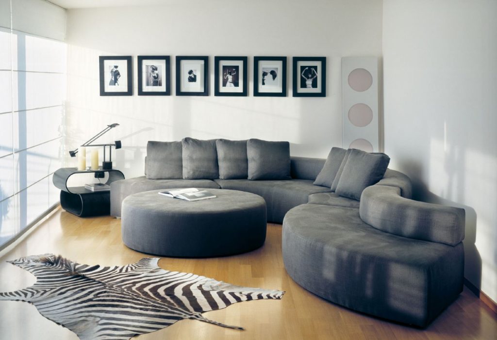 modular sofa made on a wooden base and covered in a gray snake-shaped fabric