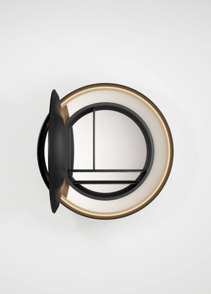 round mirror made of a wooden base covered in polished metal in a black and gold colour tone