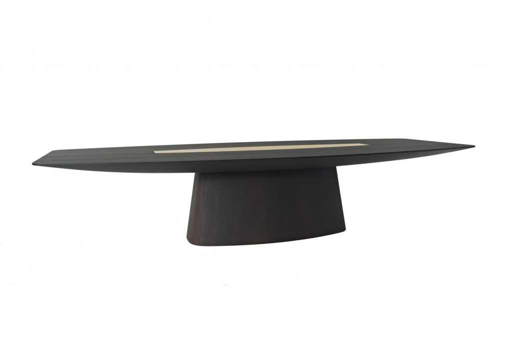 designer table made on a solid wood base in the shape of an oval in a black colour tone with brass details