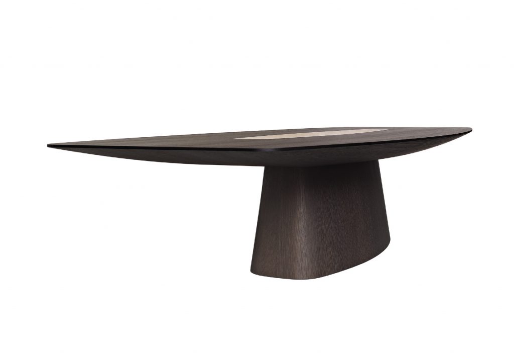 designer table made on a solid wood base in the shape of an oval in a black colour tone with brass details