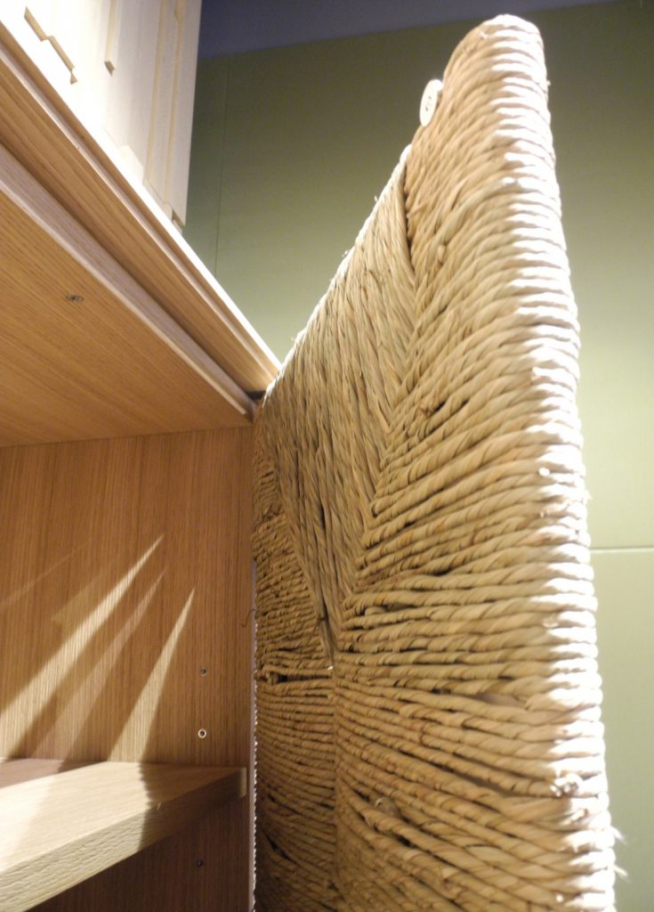 furniture door made of wood covered with straw in a beige tone