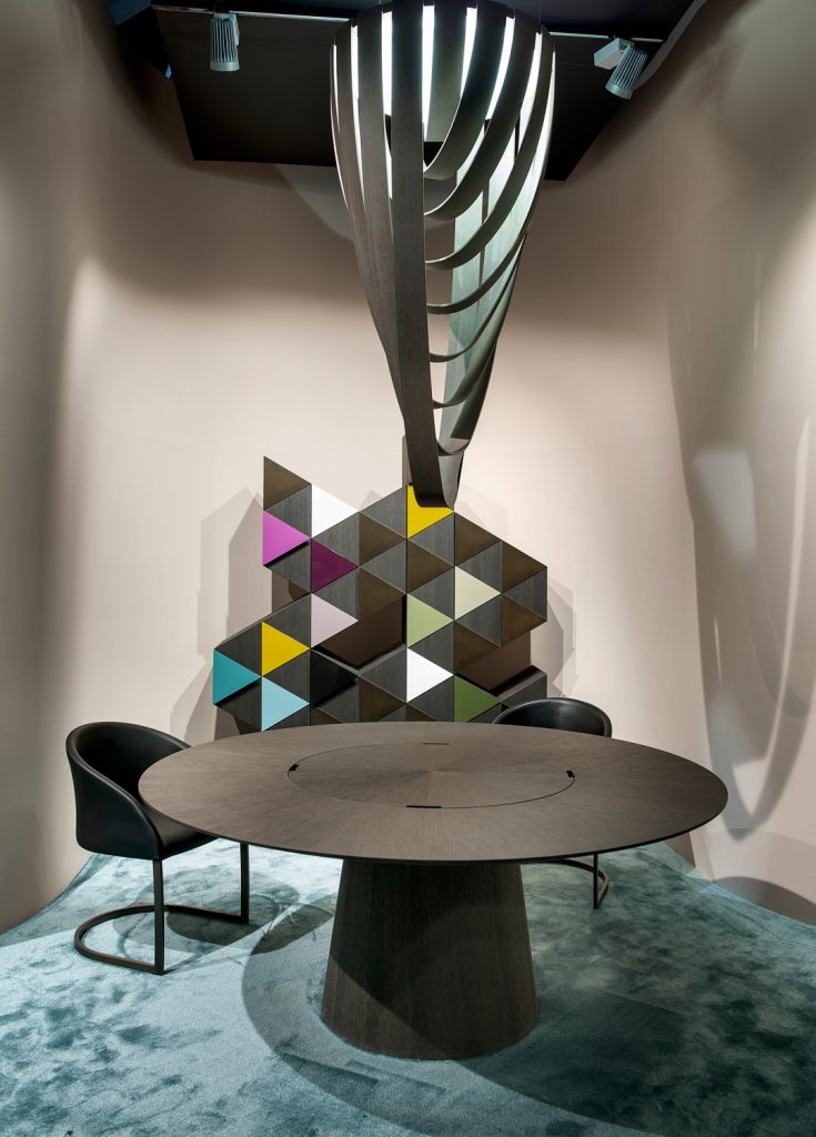circular table made of a wooden and glass base in a black colour tone in a living room