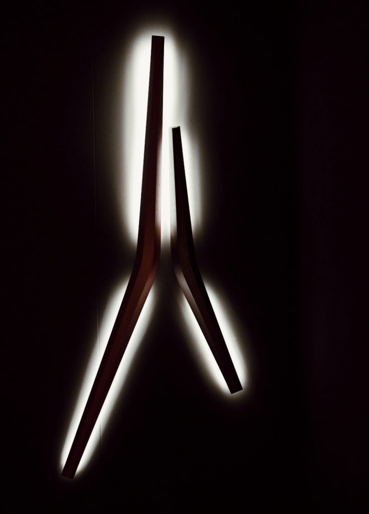 two ceiling lamps made of brass base in the form of strips in a bronze colour tone on a black background