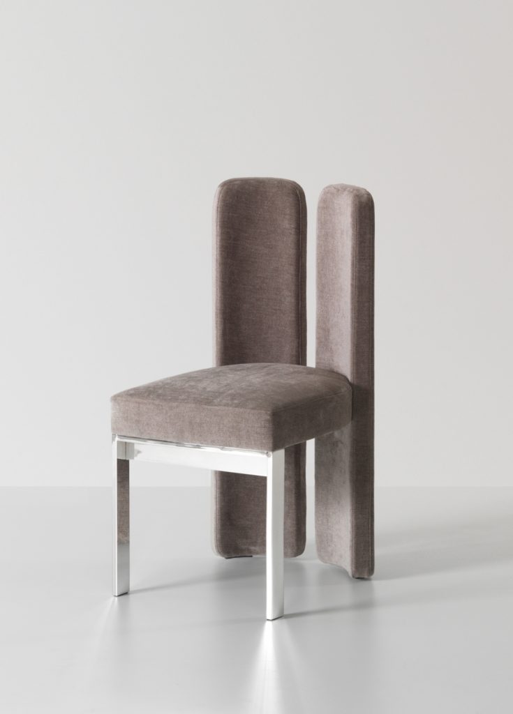 Luxurious purple velvet chair with a silver plated base.