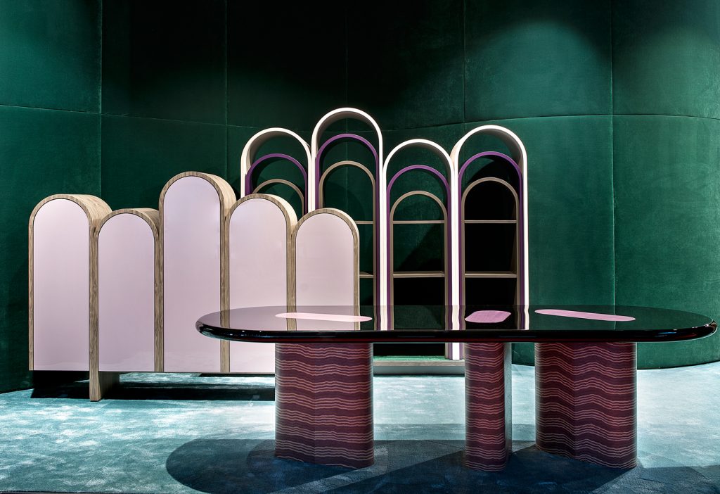 rounded-shaped storage furniture made of a wooden base in a golden and pinkish tone