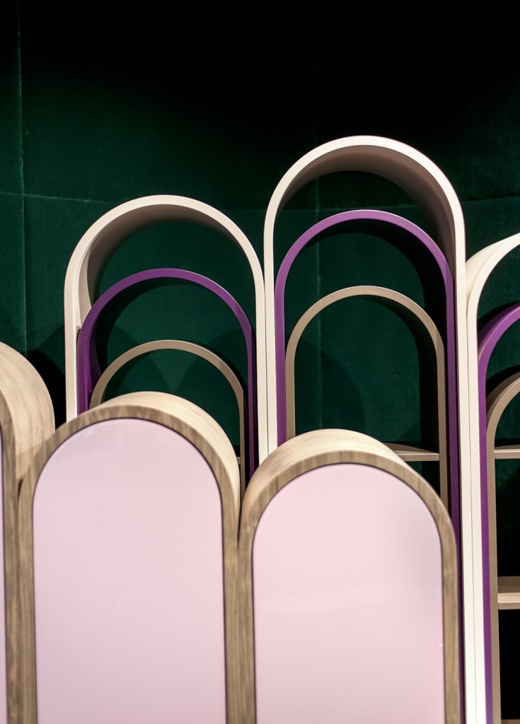 rounded-shaped storage furniture made of a wooden base in a golden and pinkish tone