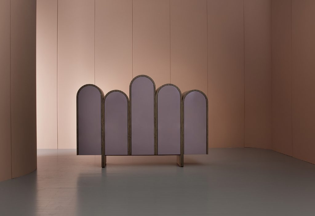 rounded-shaped storage furniture made of a wooden base in a golden and pinkish tone