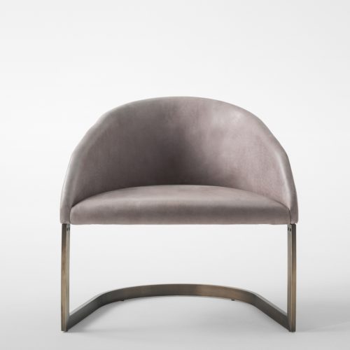 Low armchair made of a steel base and upholstered in velvet fabric in a beige colour tone