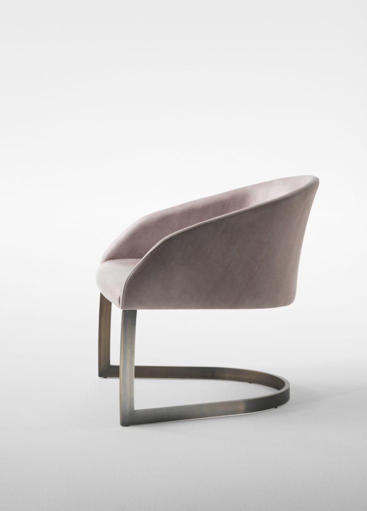 Low armchair made of a steel base and upholstered in velvet fabric in a beige colour tone