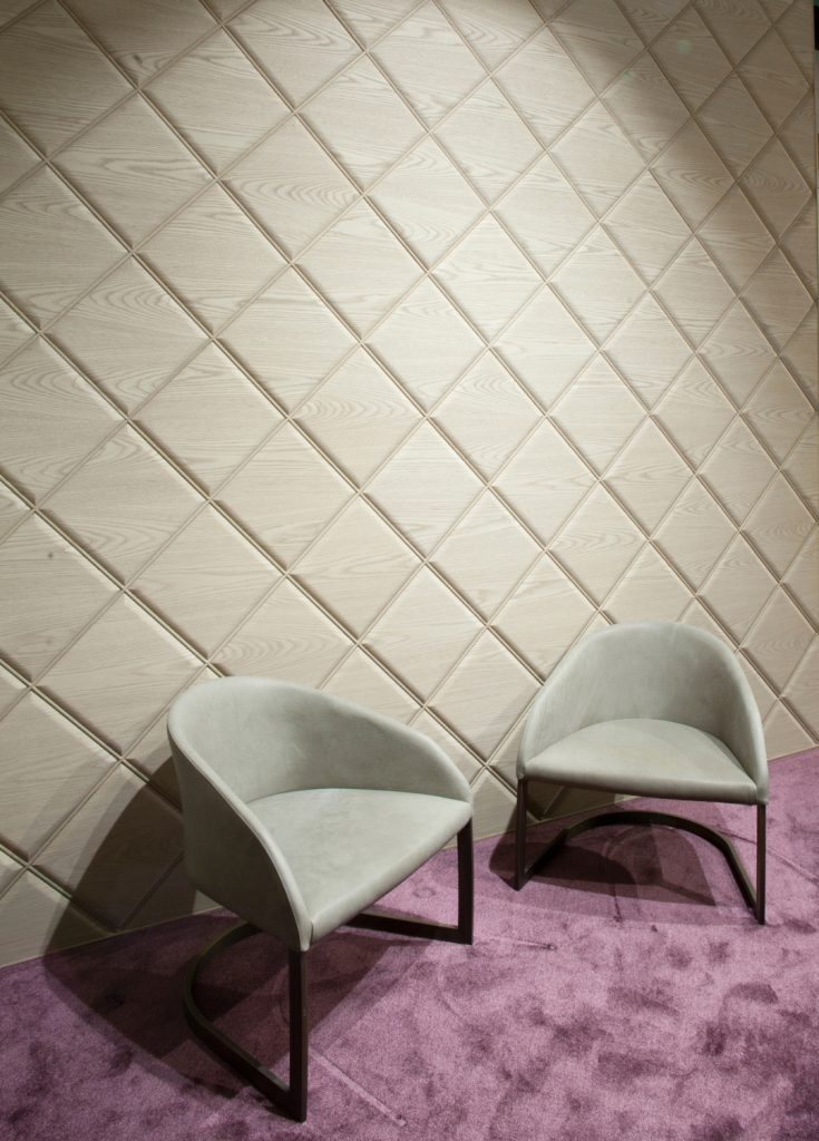 Two low armchair made of a steel base and upholstered in velvet fabric in a gray colour tone