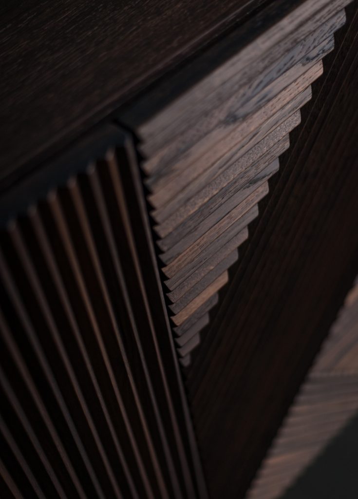 Closeup of Stripes Cabinet: Large cabinet with brown vertical striped pattern and multiple drawers.