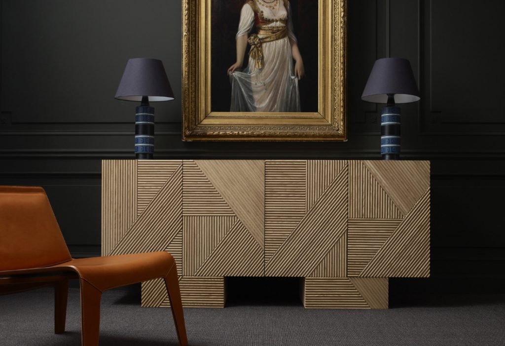 Closeup of Stripes Cabinet: Large cabinet with brown vertical striped pattern and multiple drawers in front of a black wall.