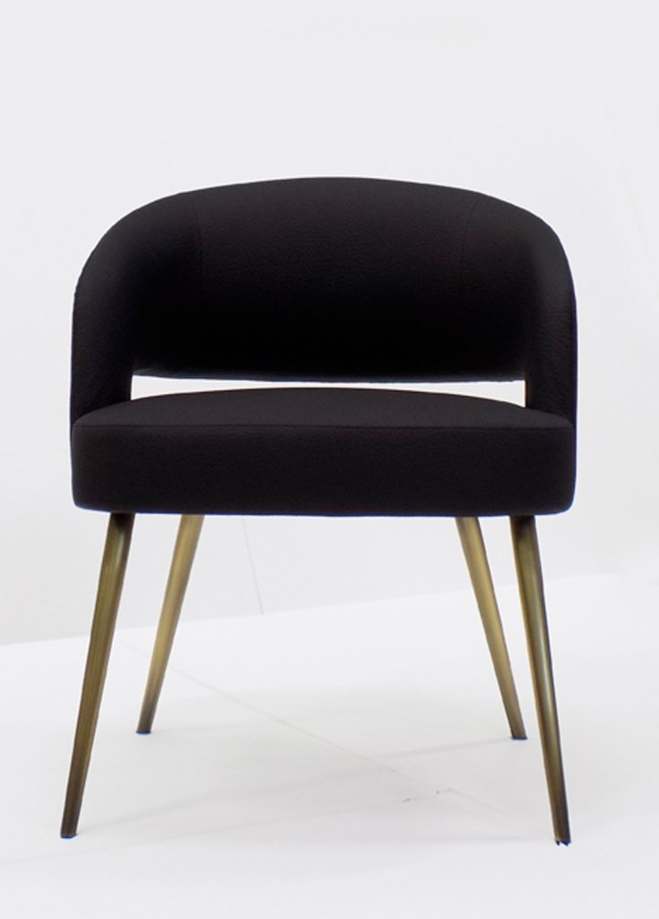 armchair made of a wood and metal base upholstered in leather in a black tone on a white background