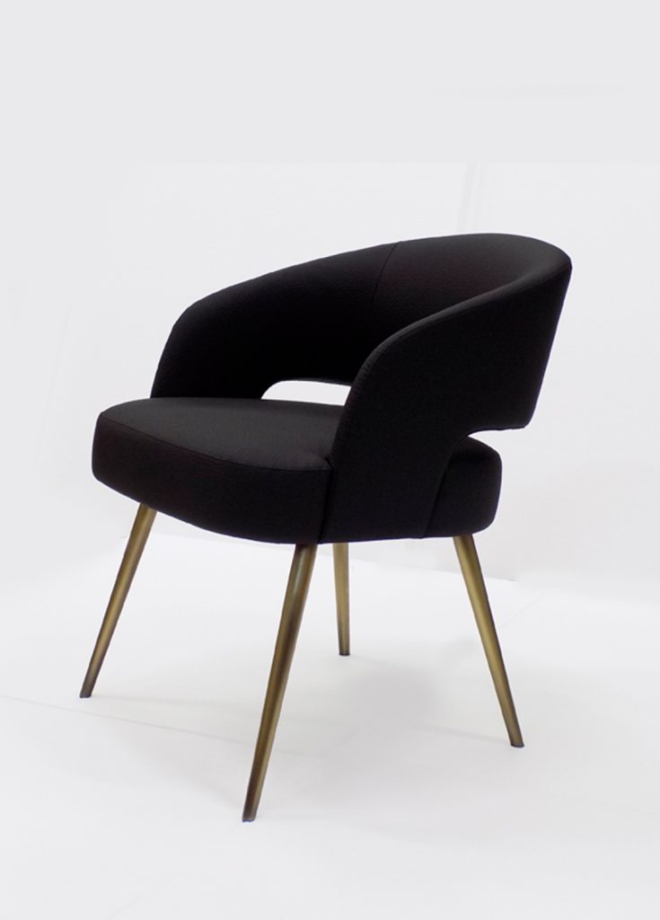 armchair made of a wood and metal base upholstered in leather in a black tone on a white background