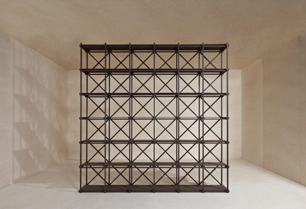 Shelving made on the basis of solid wood beams in brown tones on a yellow background