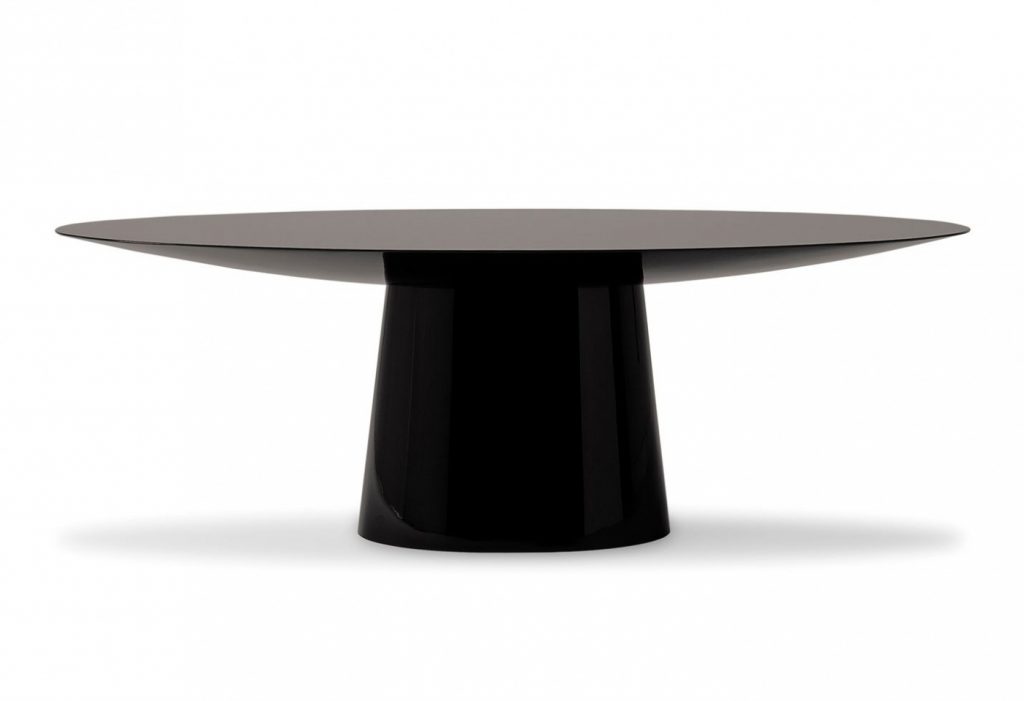 oval table made on a wooden base and lightly covered with leather and veneer in a black colour tone on a white background