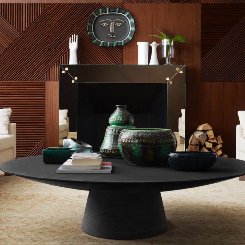 Low centrepiece made in the shape of a circle in solid wood in a black colour tone in a living room