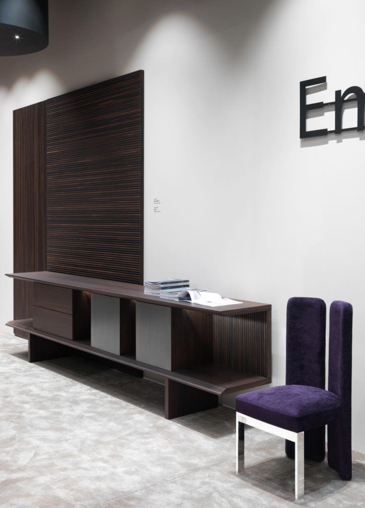 wall covering with a line-shaped design made of oak wood base in a dark brown colour tone on a living room