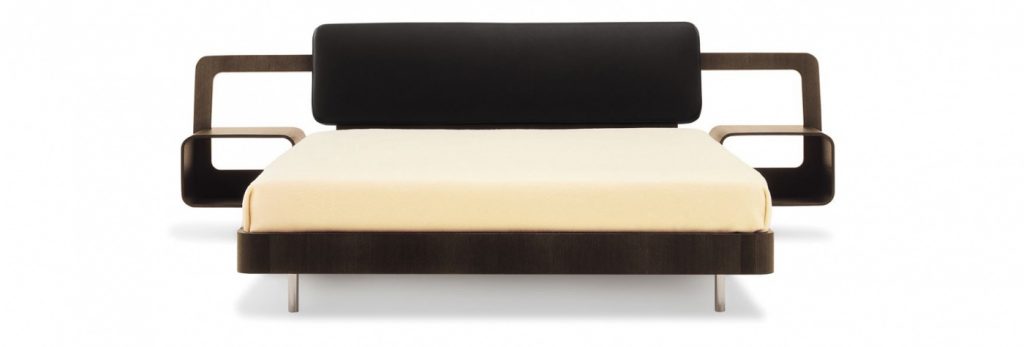 Bed made of a wooden base covered in leather in a white, black and brown colour tone on a white background