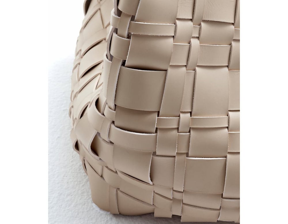 A detailed close-up of the 10th Baskets Tray showcasing its intricate woven leather design with a soft neutral tone and fine craftsmanship