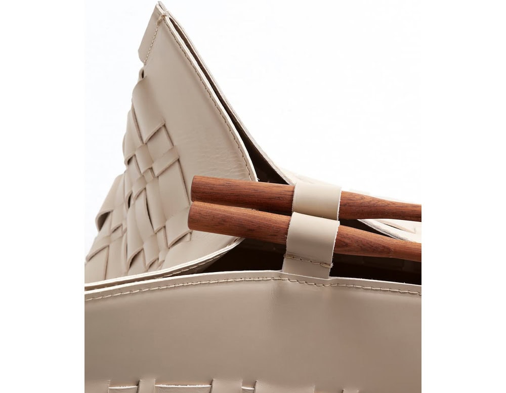 A detailed close-up of the 10th Baskets Tray showcasing its elegant woven leather design wooden handle accents and precise craftsmanship