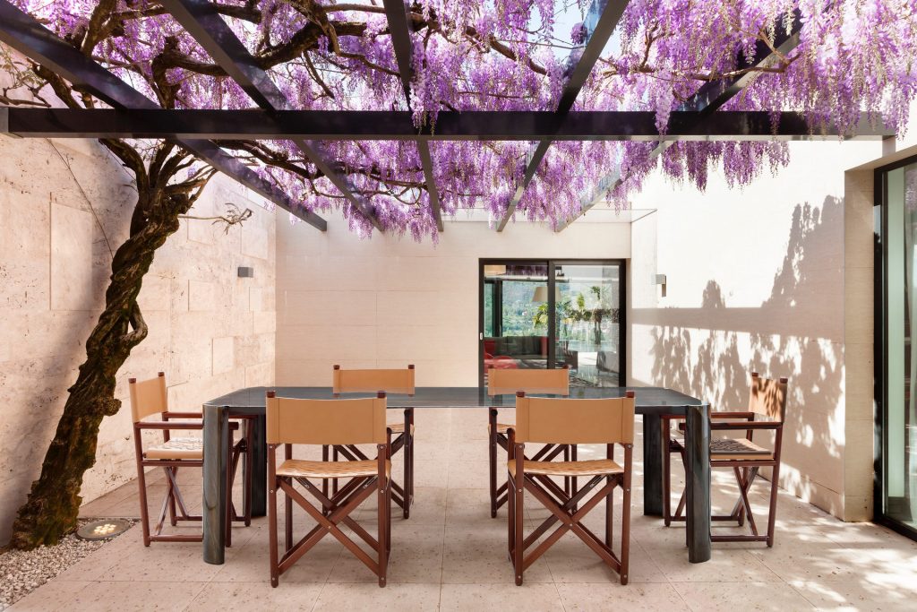 10th Bridge Table: Rectangular table with a wooden top and four legs on a terrace.