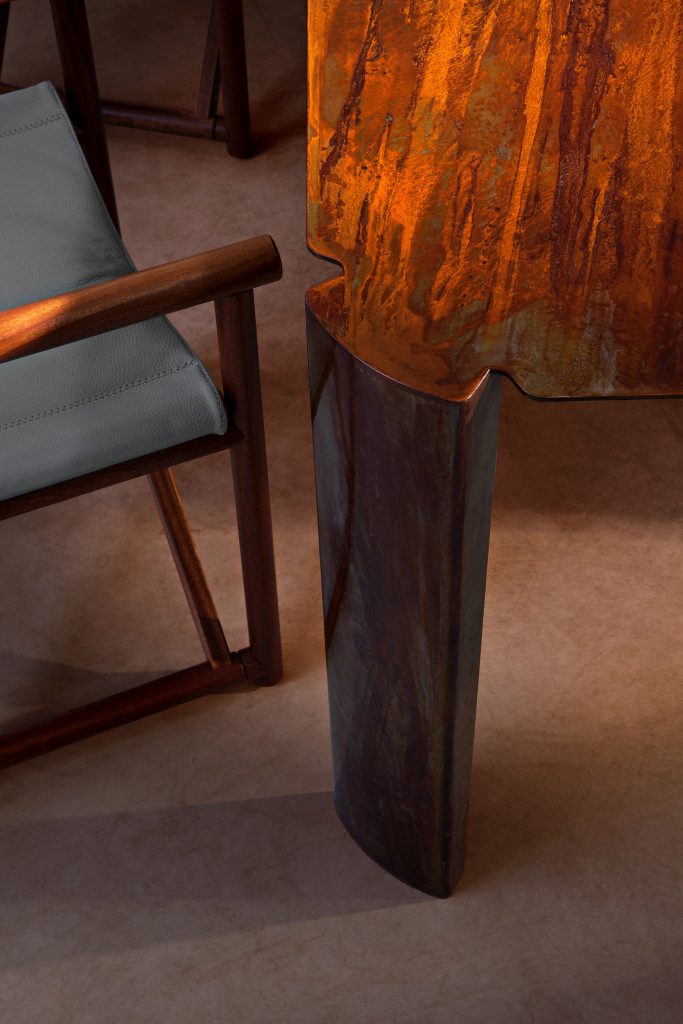 Closeup of 10th Bridge Table: Rectangular table with a wooden top and four legs on a terrace.