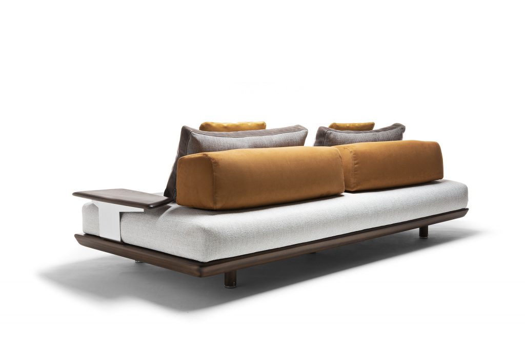 Caprera Sofa: Large gray cushioned sofa with wooden frame on a white background.