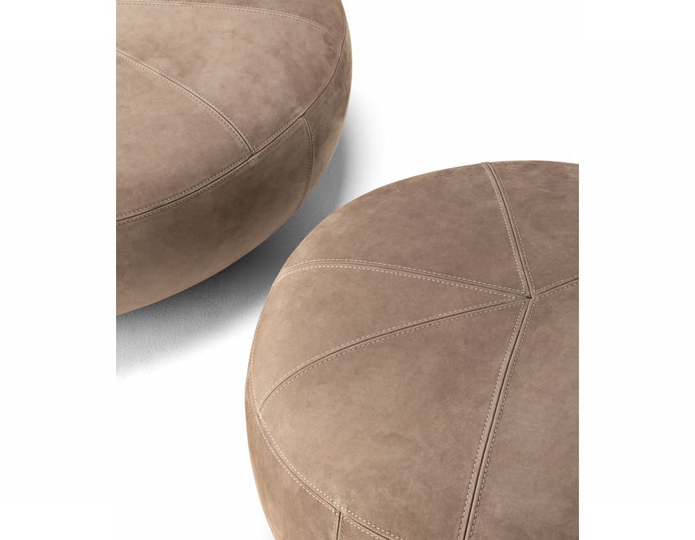 Two 10th Clove Outdoor Poufs with textured brown fabric are partially visible against a white background, highlighting their rounded shapes