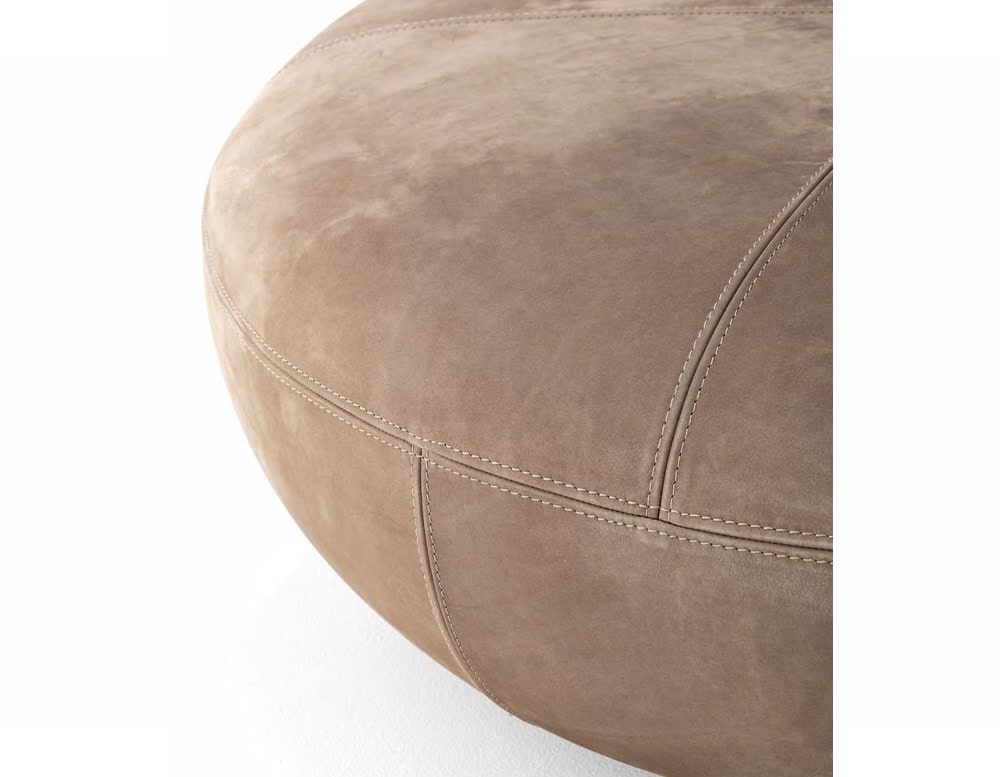 A close-up of a 10th Clove Outdoor Pouf shows a textured brown fabric with a distinct seam and rounded edge against a white background