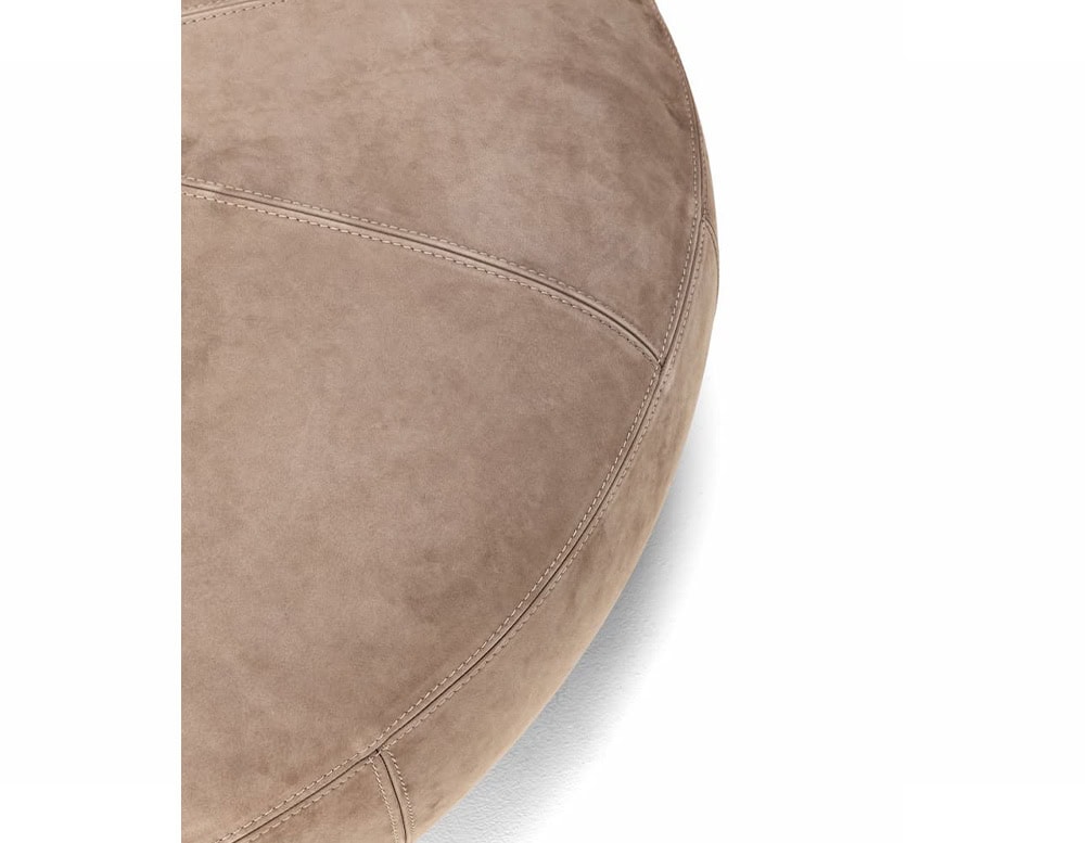 A close-up of a 10th Clove Outdoor Pouf shows a textured brown fabric with a rounded edge against a white background