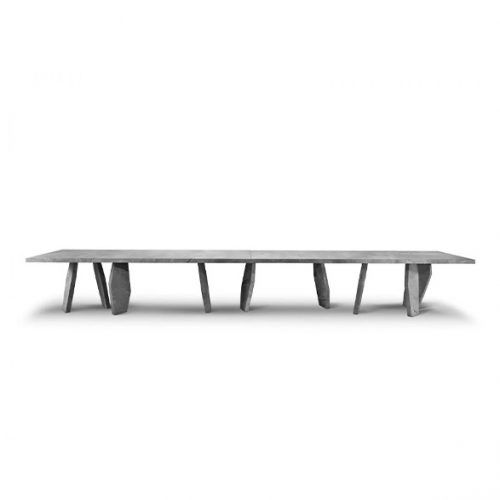 A 10th Joint Dining Table with a long, dark rectangular top and multiple cylindrical legs is shown from a low angle against a white background