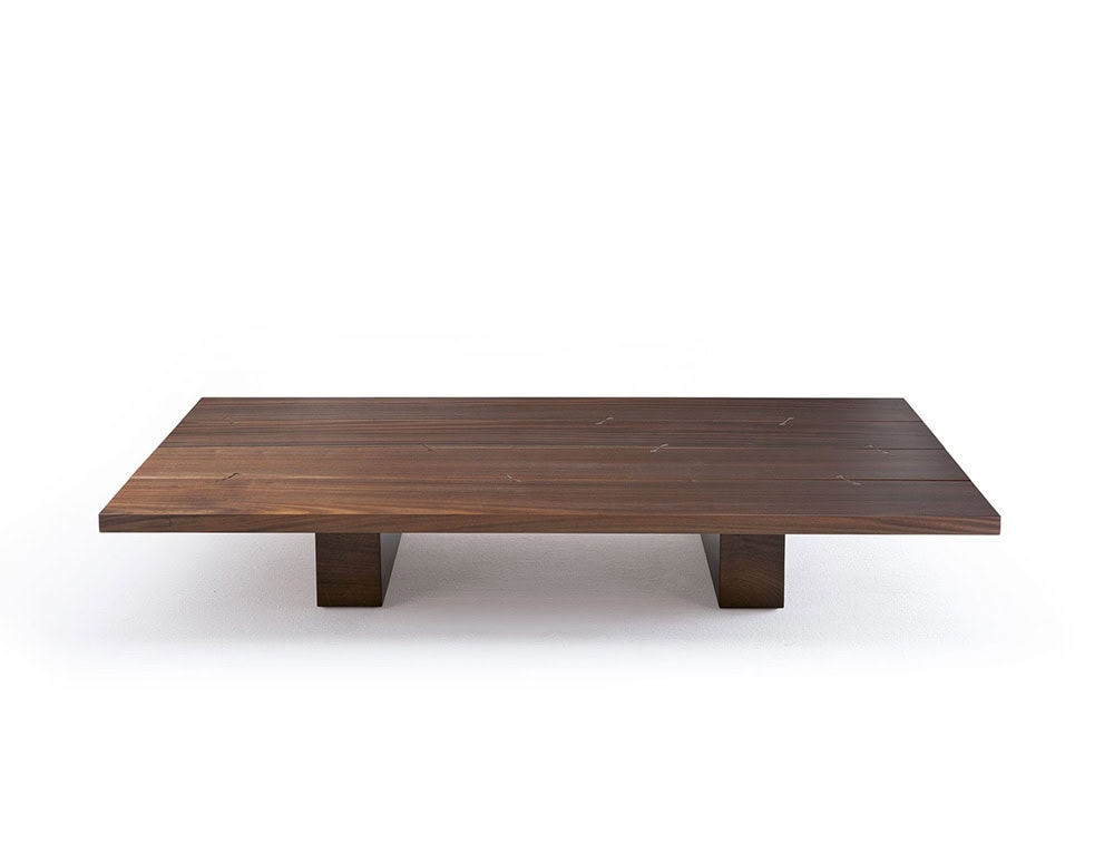 A studio shot of the Joint Rectangular Coffee Table featuring a sleek wooden design with a broad surface and sturdy block-style legs