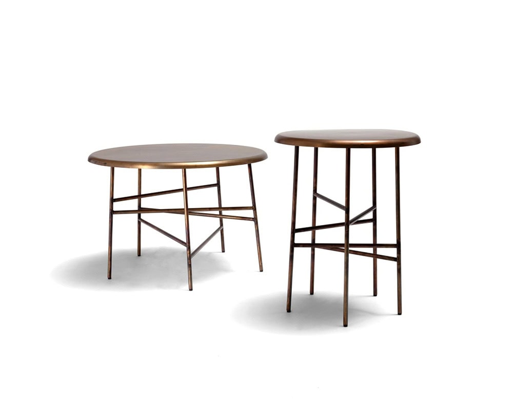 A 10th Star Coffee Table and a 10th Star Side Table are shown side-by-side against a white background; both pieces have round tops and dark metal bases with a starburst design