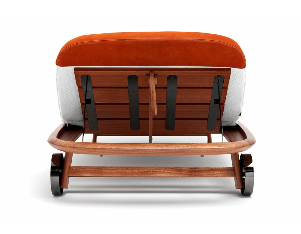 Rear view of the 10th Tellaro Sun Lounger with an orange cushion, white frame, wood slats, and wheels, shown on a white background.