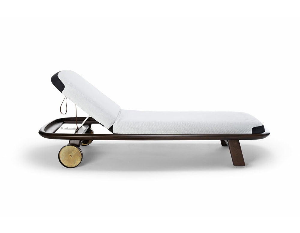 A 10th Tellaro Sun Lounger with a white cushion and dark frame is shown in profile, highlighting its adjustable back and small wheels on a white surface.
